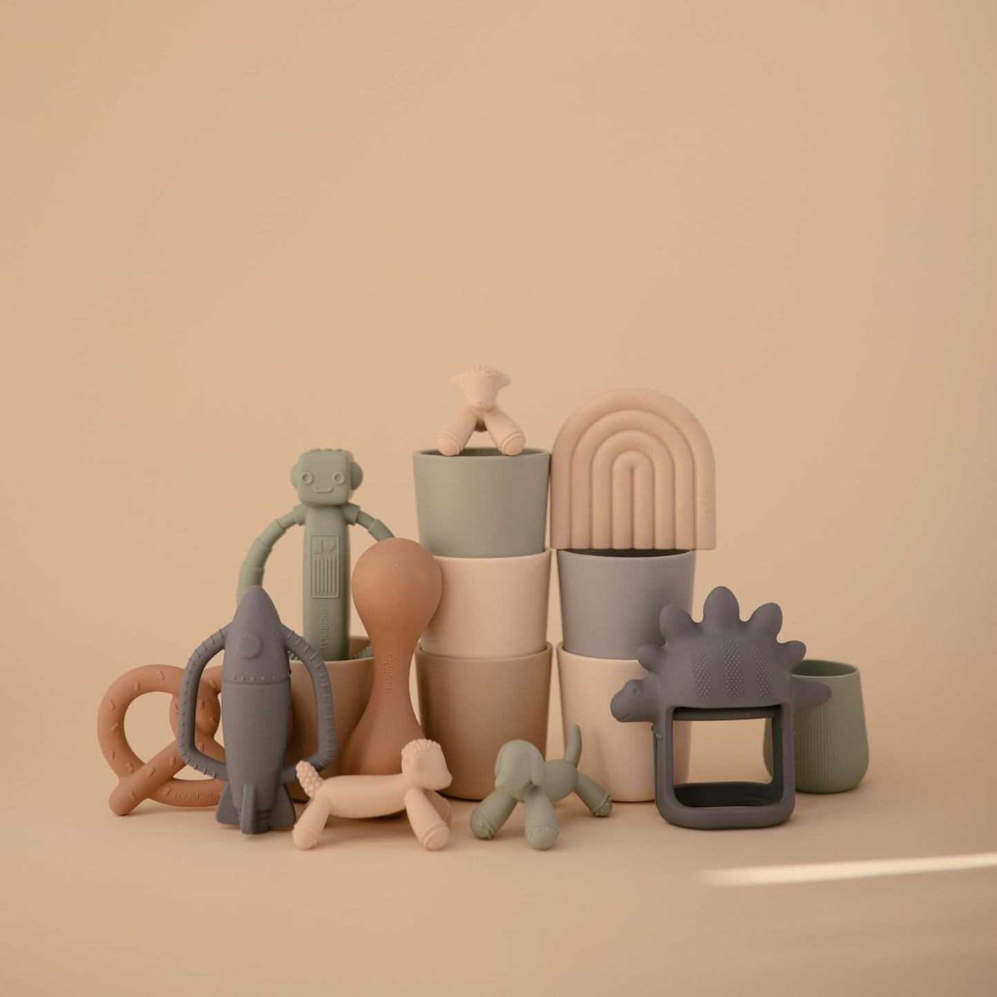 Collection of colorful ceramic vases and sculptures on a beige background